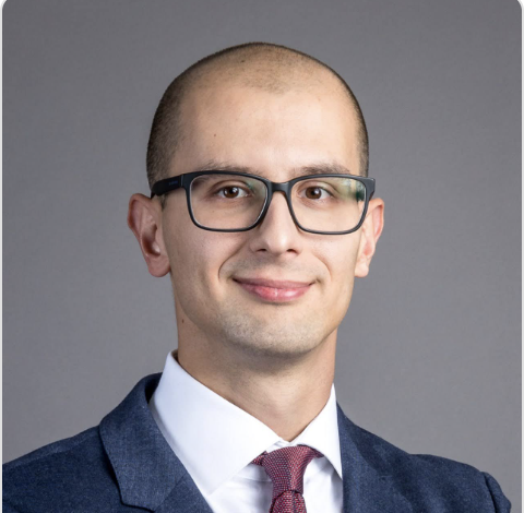 Headshot portrait of Jurij Skornik, General Manager at Trace Labs (OriginTrail core devs), in a suit and tie, smiling.