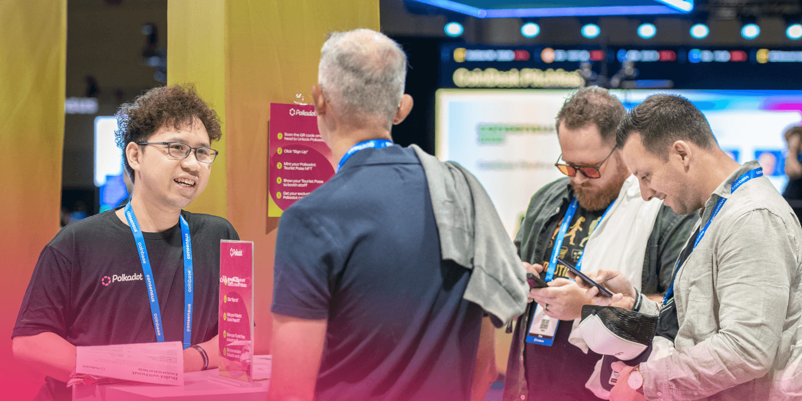 Polkadot team member explains the onboarding flow to Consensus attendees as they engage with the booth and scan their phones to get started.