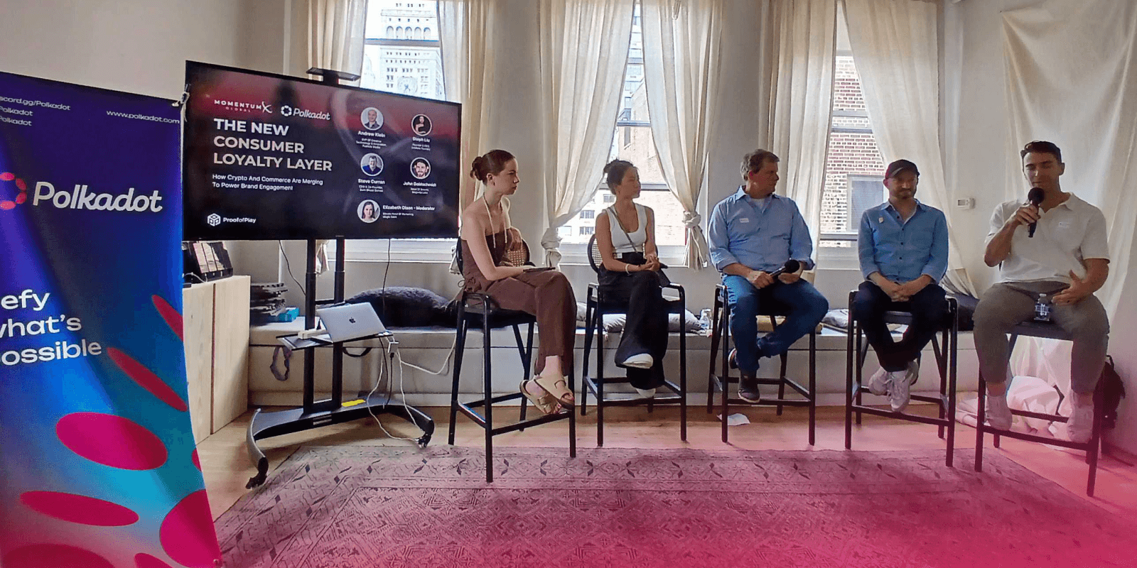 A panel of 5 speakers talk in a meeting room at the Verci co-working space in NYC